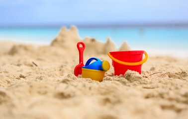 Sand castle on beach and kids toys