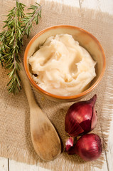 bowl with lard, rosemary, lilac onion and wooden spoon