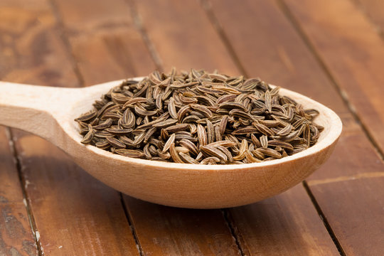 cumin seeds in wooden spoon