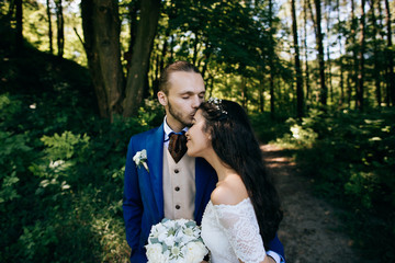 Bride and groom at wedding Day embracing with love. Happy romantic young couple celebrating their marriage