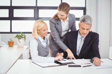 Business people explaining client with documents