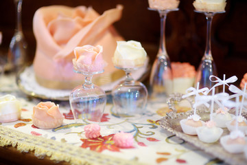 Beautiful desserts, sweets and candy table at wedding reception