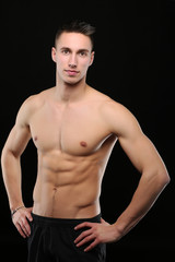 Fototapeta premium Portrait d'un bel homme torse nu sur fond noir
