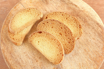 Healthy snack rusk, made from whole-wheat flour, on a wooden table.