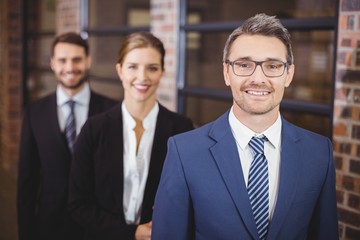 Happy business people standing in row
