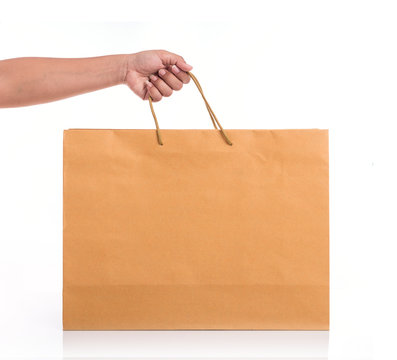 Close Up Hand Holding Brown Paper Bag Isolated On White