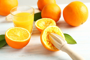 Citrus fruits with juicer on a blue wooden table