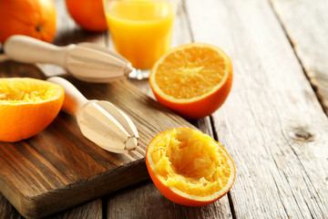 Citrus fruits with juicer on a grey wooden table