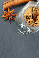 Cinnamon and Star anise on a grey stone background with copy space.