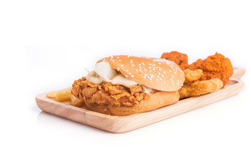 Fried chicken, french fries and soft drink on wooden table
