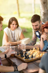 Young people are focused on chess game