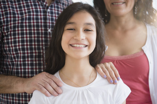 Hispanic girl smiling with parents
