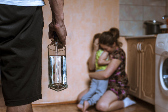 Woman Covering Her Child From Angry Drunk Father