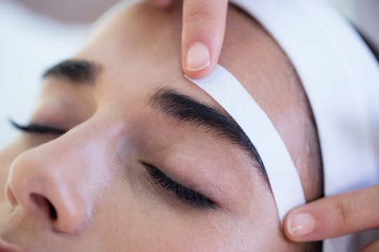 Woman getting her eyebrows shaped
