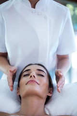 Obraz na płótnie Canvas Woman receiving massage from masseur