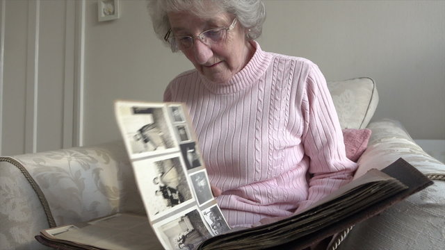 Senior woman looks at photo album
