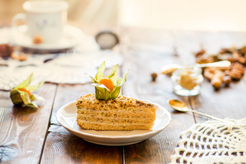 Obraz na płótnie Canvas slices of cake with a cream with tea set on a served table