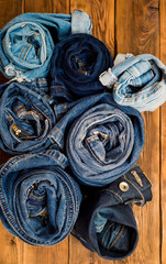 twisted jeans on a wooden background. Above view