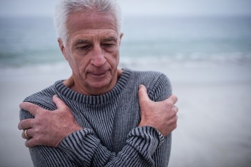 Senior man in sweater feeling cold