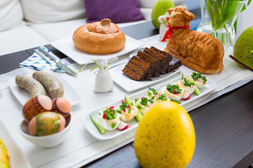 Easter traditional polish breakfast with white borsch soup in bread bowl, eggs and white sausages