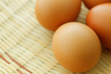Eggs on woven rattan tray. Selected focus.
