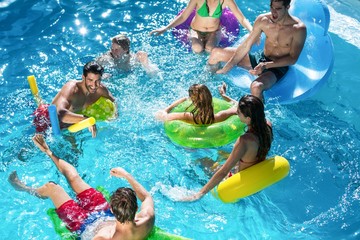 Group of friends having fun in swimming pool