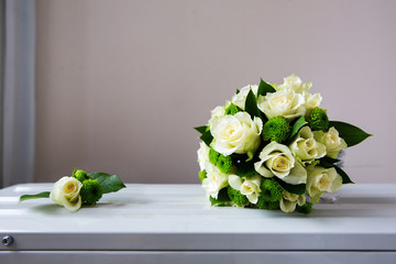 Wedding bouquet and boutonniere of white flowers