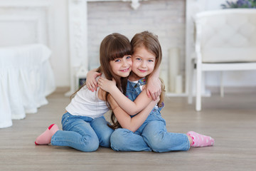 little girls hugging and laughing