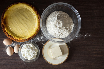 Homemade cheesecake with ingredients around.