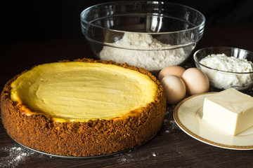 Fresh baked cake with butter flour and eggs around