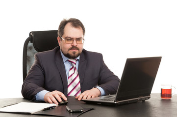 the businessman sits at office table