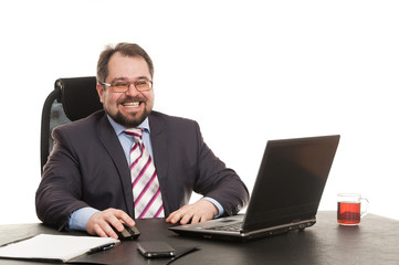 the businessman sits at office table