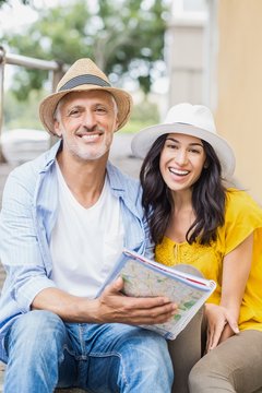 Portrait of happy couple with map