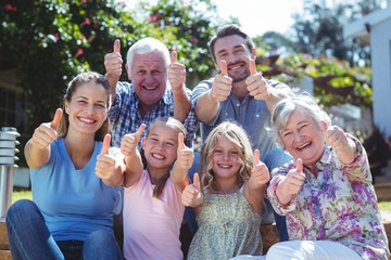 Portrait of family gesturing thumbs up
