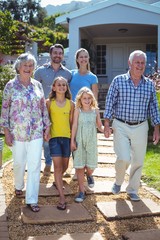 Happy multi-generation family walking on footpath