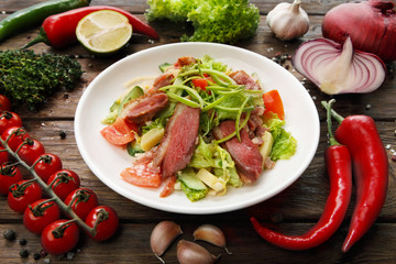 Restaurant food closeup - salad with prosciutto