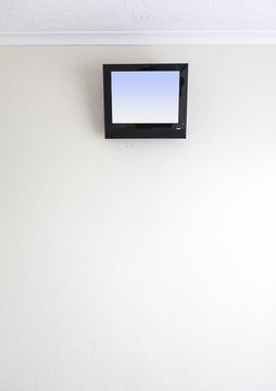 small TV on motel wall