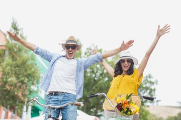 Portrait of excited couple with bicycles