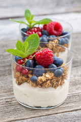 dessert with milk cream, muesli and berries, closeup