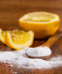 baking soda (sodium bicarbonate) in a wooden spoon and lemon
