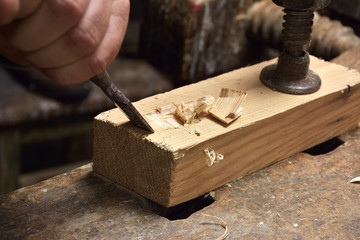 carpenter working with plane on wooden