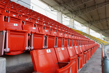 Fototapeta premium Red seats on the grandstand in the stadium