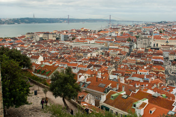 Fototapeta na wymiar Vista from Sao Jorge Castle over Lisbon's Baixa neighbourhood with Tagus river, Cristo Rei statue and 25 de Abril bridge.