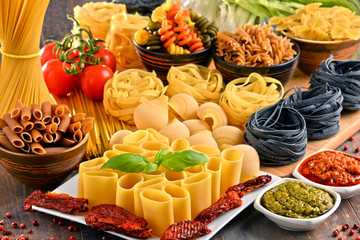 Composition with variety of pasta on kitchen table