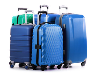 Five plastic suitcases isolated on white
