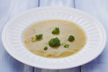 vegetable soup in white bowl on blue wooden background