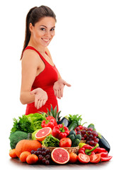 Young woman with variety of organic vegetables and fruits