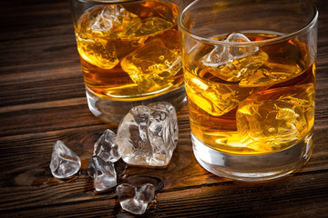 Two glasses with ice and whiskey