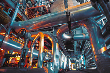 Equipment, cables and piping as found inside of a modern industr