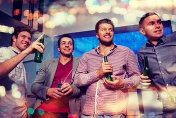 group of male friends with beer in nightclub